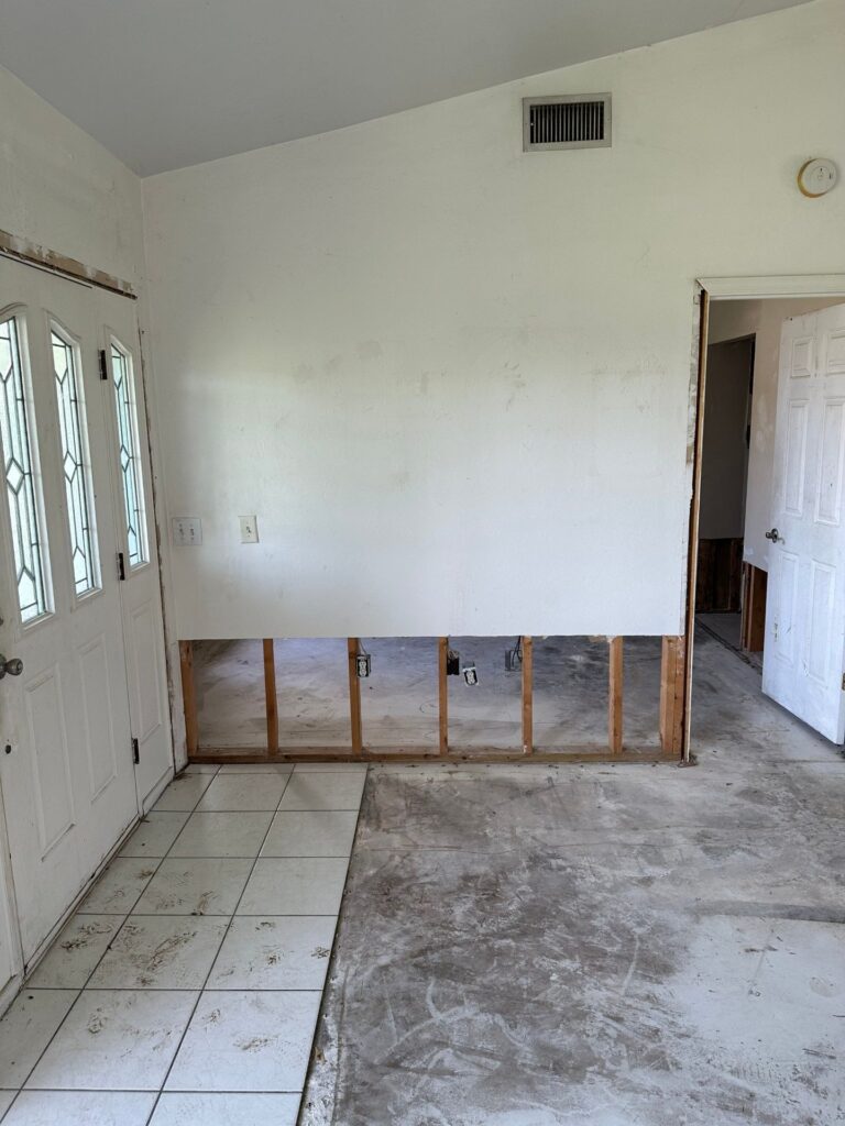 Flood cuts along the walls of a Cape Coral, FL home after water damage